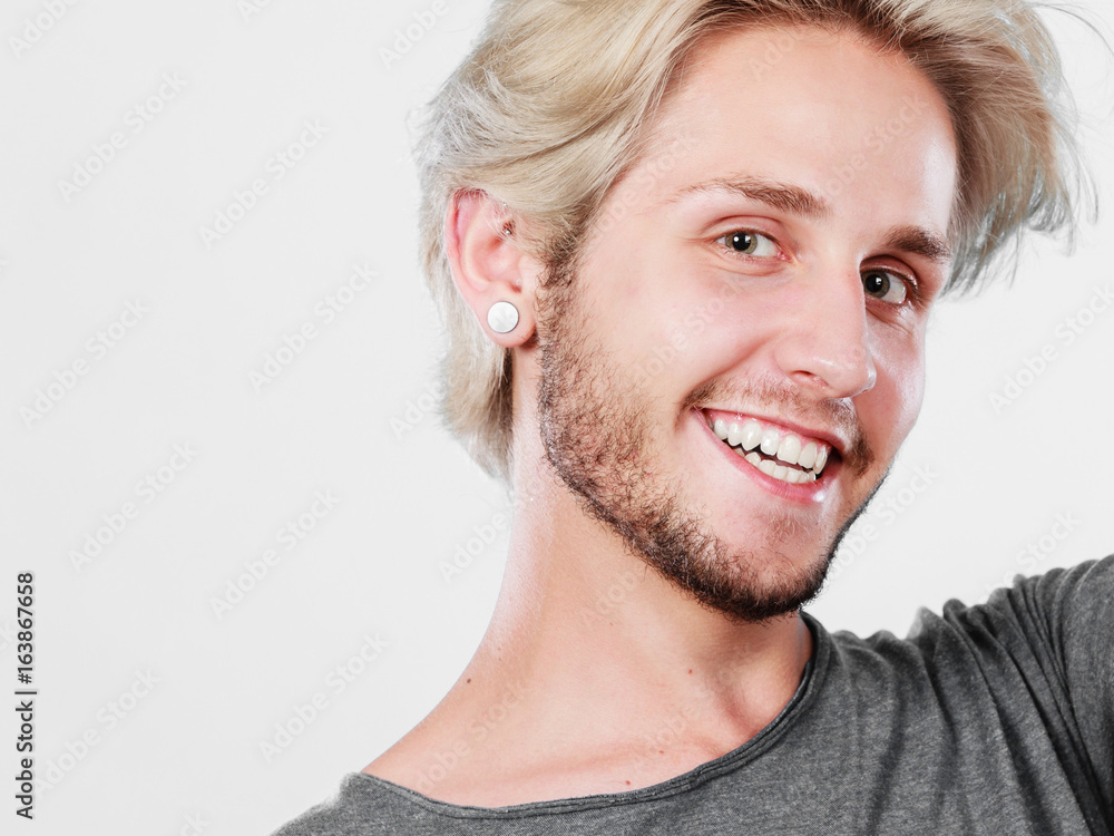 Happy smiling blonde man in grey t shirt Happy smiling blonde man in grey t shirt