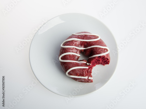 donut or donut with missing bite on a background.