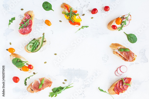 Traditional spanish tapas on white table. Brushetta set. Flat lay, top view, copy space