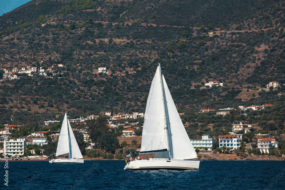 Luxury yachts at Regatta around the coast of Greece. Sailing in the wind through the waves at the Sea.