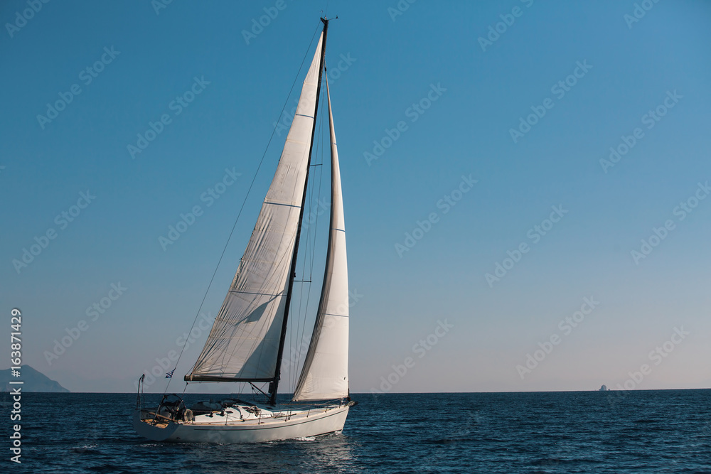 Sailing in the wind through the waves at the Sea. Sailors luxury yacht boat in the Aegean.