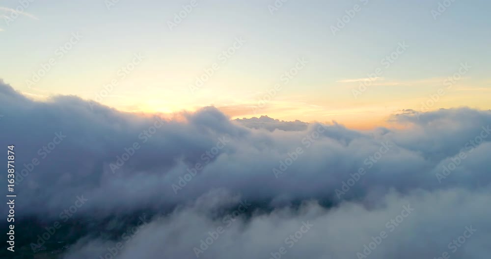 Aerial View Flying Through Clouds at Sunset Aerial View Flying Through Clouds at Sunset