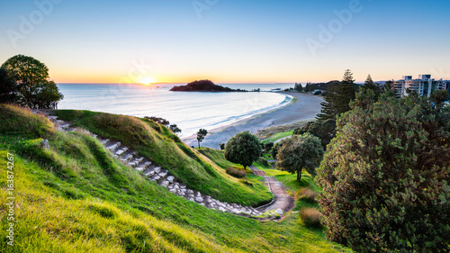 Sunrise at summit track on Mount Maunganui, New Zealand photo