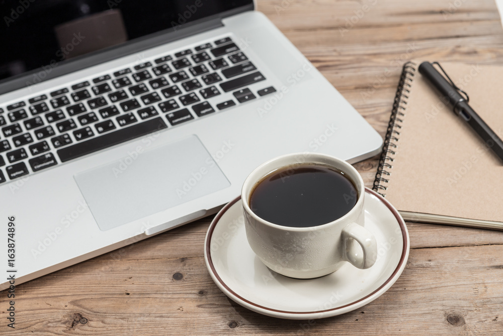 office working desk top view with laptop, notepad and coffee
