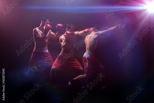 The boxer boxing in a dark studio