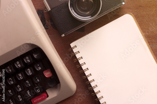 Coffee notebook and glass on wooden table