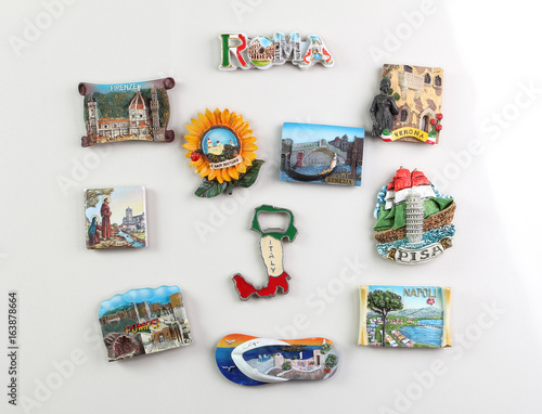 Souvenir magnets of the cities of Italy on the door of the refrigerator