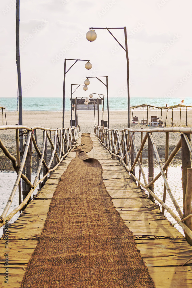 Wooden pedestrian bridge to the sea.