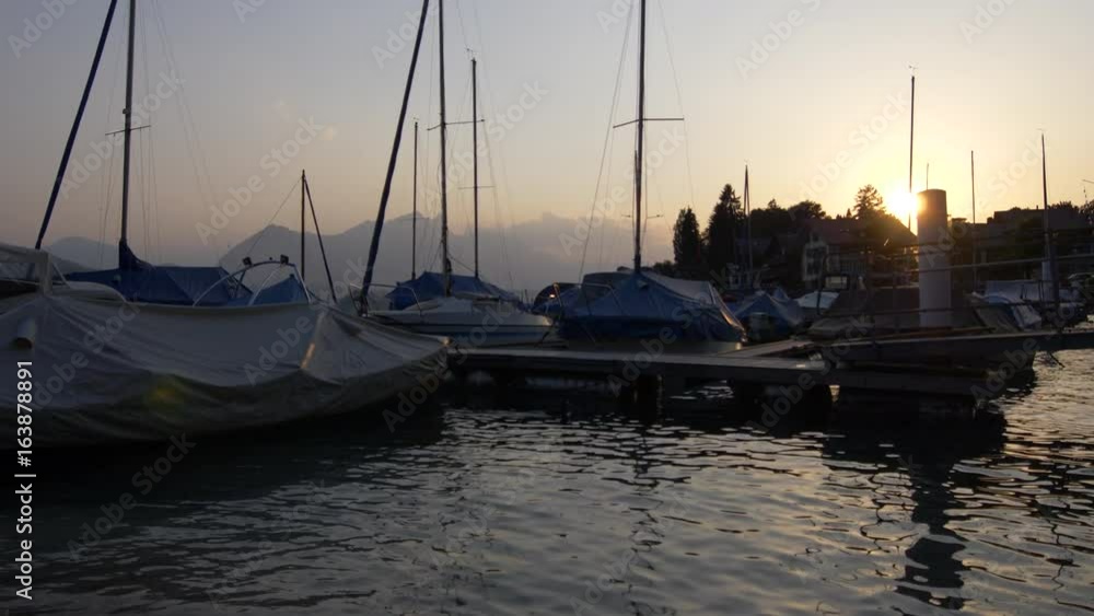 Sunset at the Lake Thun. Boats in the Marina. Jungfrau Region, Switzerland. Sunset at the Lake Thun. Boats in the Marina. Jungfrau Region, Switzerland.