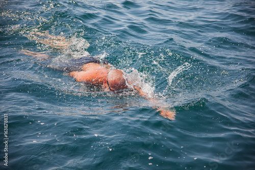 Swimming man in sea.