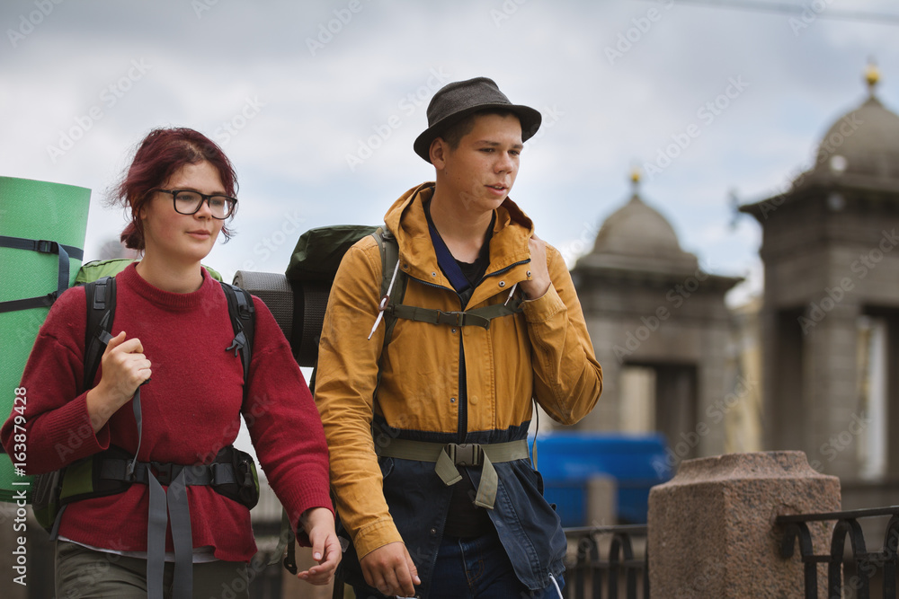 Fototapeta premium Young couple of tourists walk the streets of the city