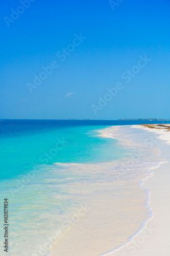 Perfect white sandy beach with turquoise water and blue sky. Amazing picture