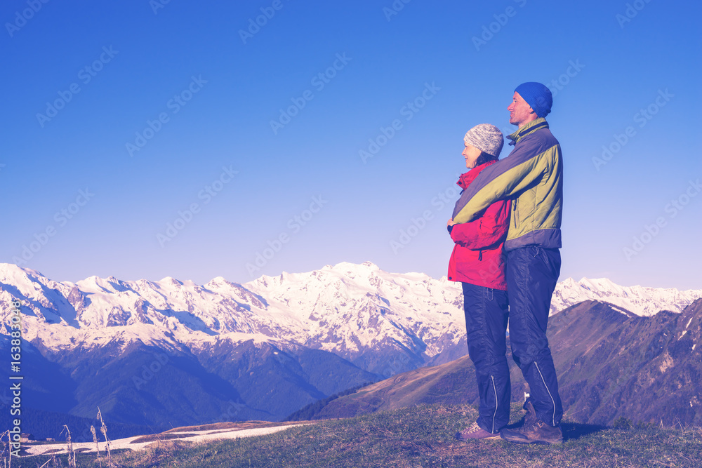 Happy couple of travelers hugging and enjoying the view