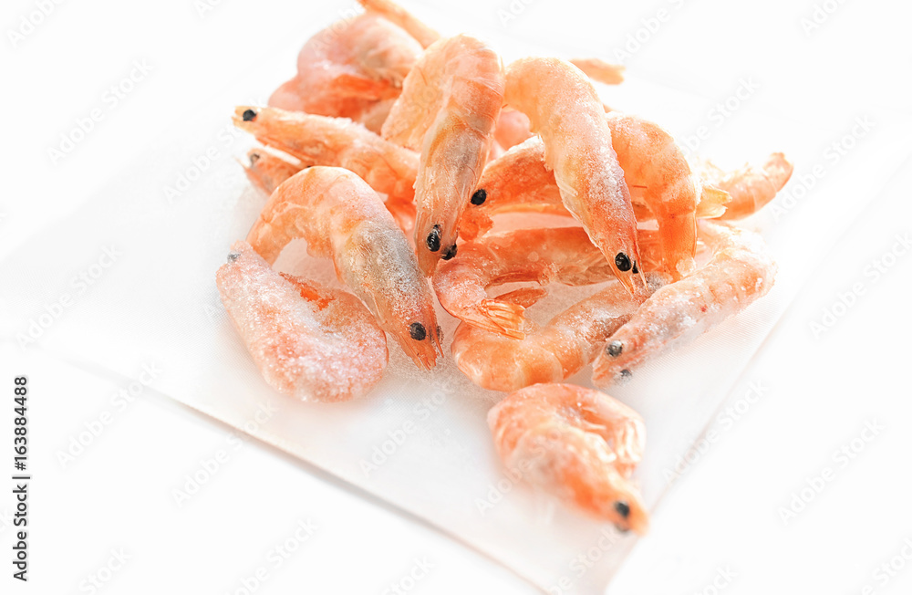 Shrimp are on the small glass dish on a white background. Shrimp are on the small glass dish on a white background.