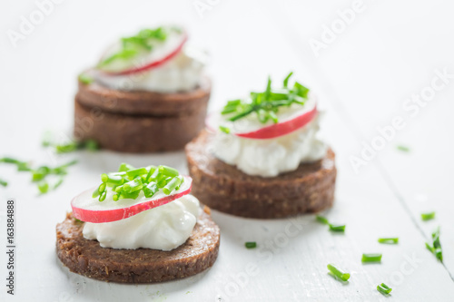 Closeup of sandwich with pumpernickel, cottage cheese and chive