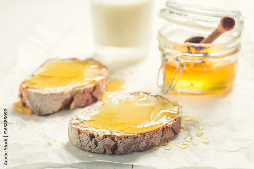 Closeup of sandwich with honey with milk for breakfast Closeup of sandwich with honey with milk for breakfast