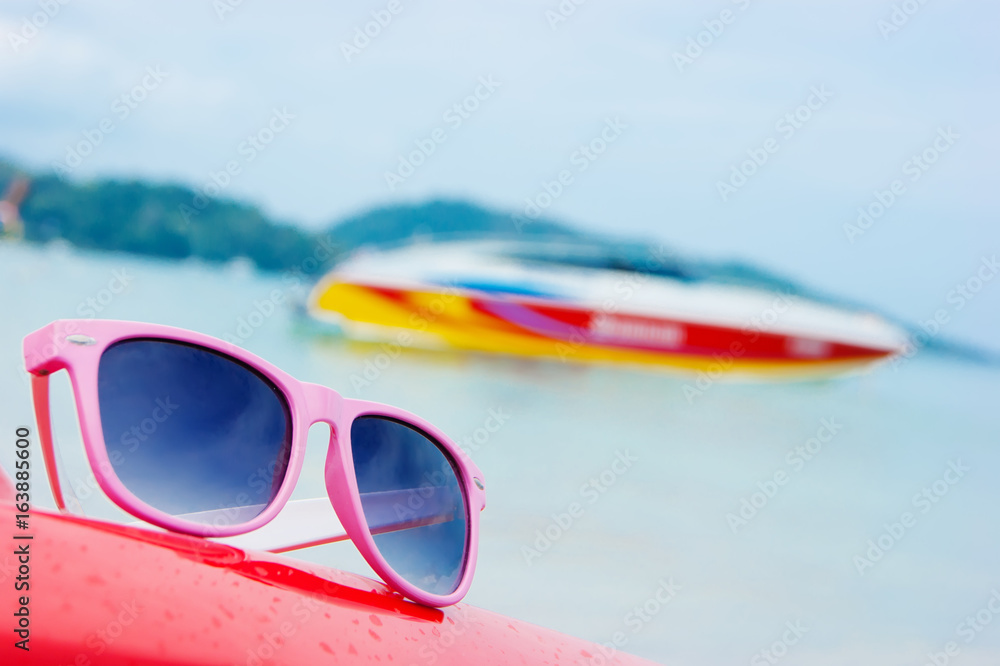 pink sunglasses on the beach