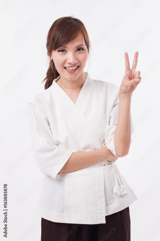 woman spa therapist pointing up 2 fingers, counting, numbering, victory hand sign woman spa therapist pointing up 2 fingers, counting, numbering, victory hand sign