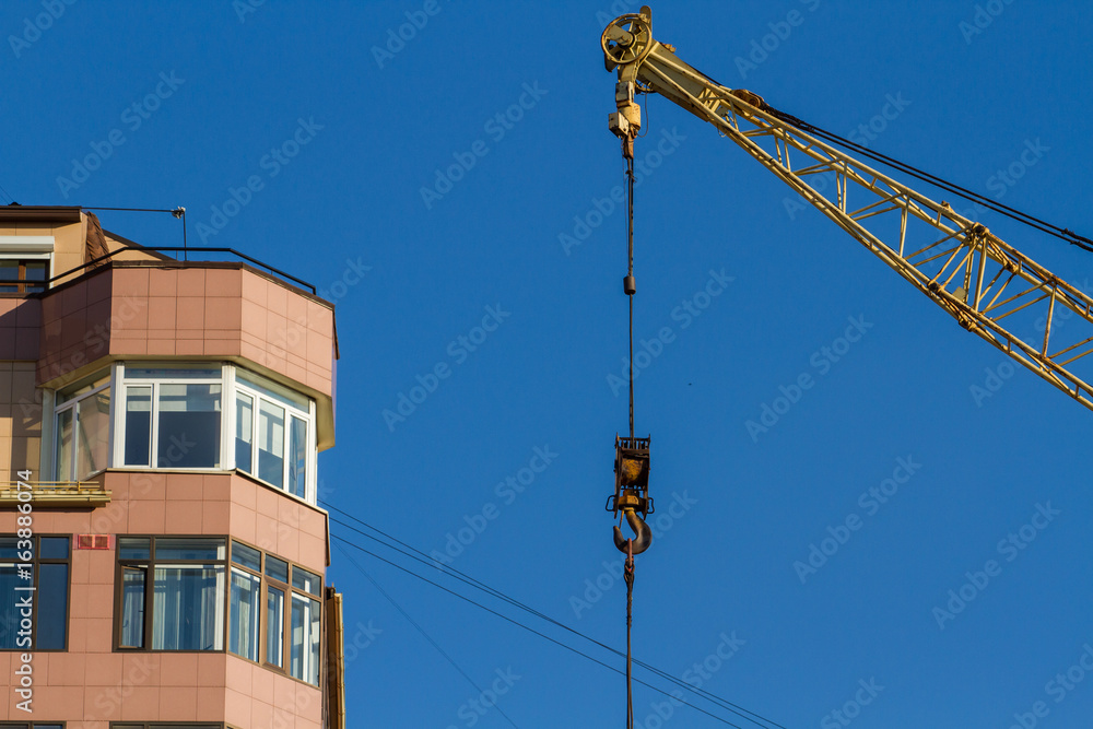 Hook of the tower crane. The end of the construction of an apartment building