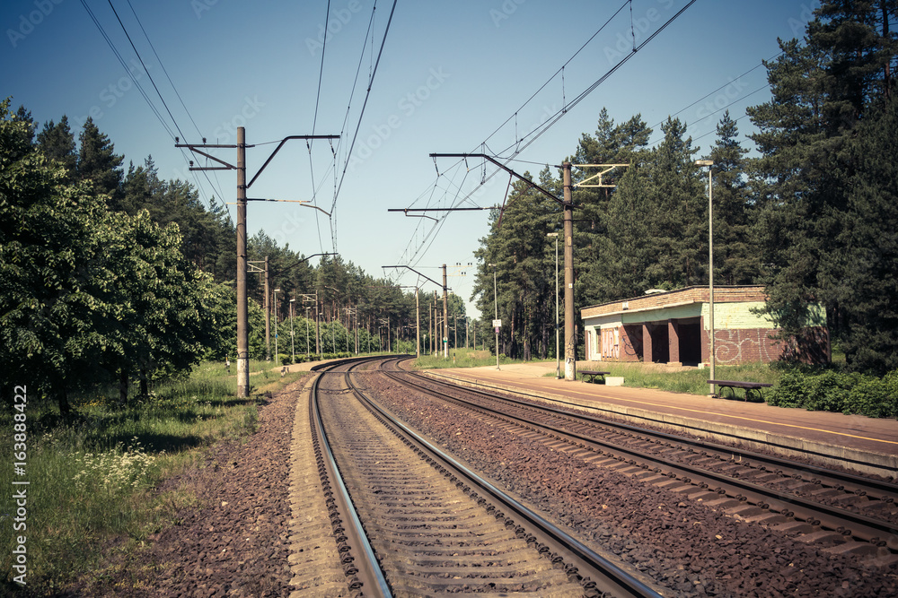 railroad tracks near an old small railroad station, transportation background
