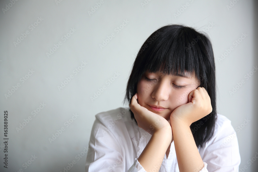 Asian young woman thinking and looking portrait in coffee shop cafe Asian young woman thinking and looking portrait in coffee shop cafe