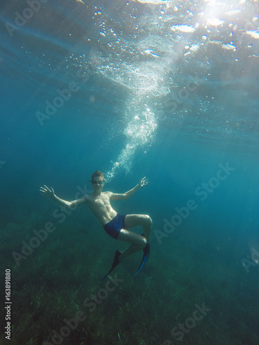Swimmer in flippers dives into the sea