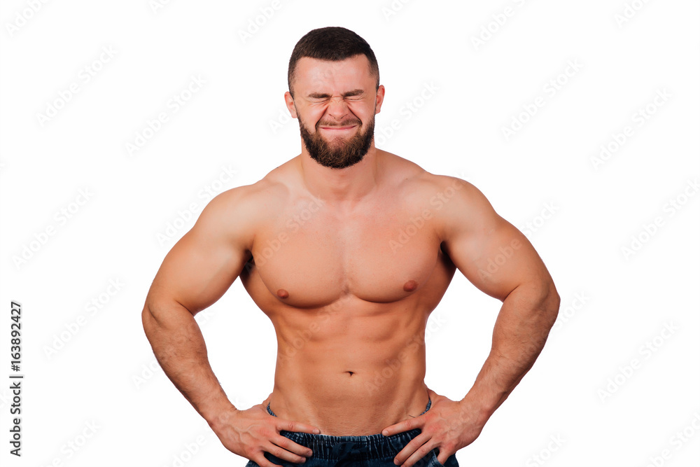Portrait of a strong bearded male fitness model, torso. White background, isolate. hands on his hips. Portrait of a strong bearded male fitness model, torso. White background, isolate. hands on his hips.