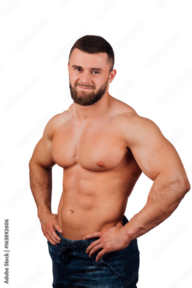 Portrait of a strong bearded male fitness model, torso. White background, isolate. hands on his hips.