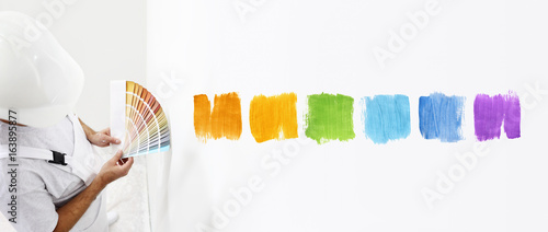 painter man with color swatches in your hand, Choice of colors concept, and color samples on white blank background