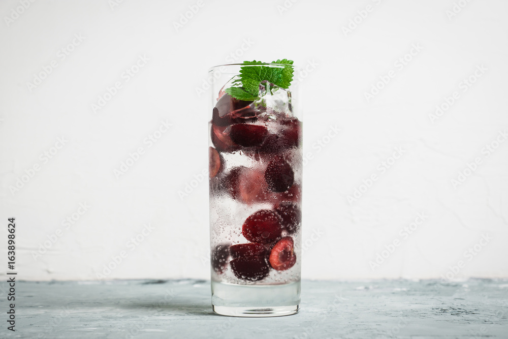 Cherries mojito on the wooden background. Selective focus. Cherries mojito on the wooden background. Selective focus.