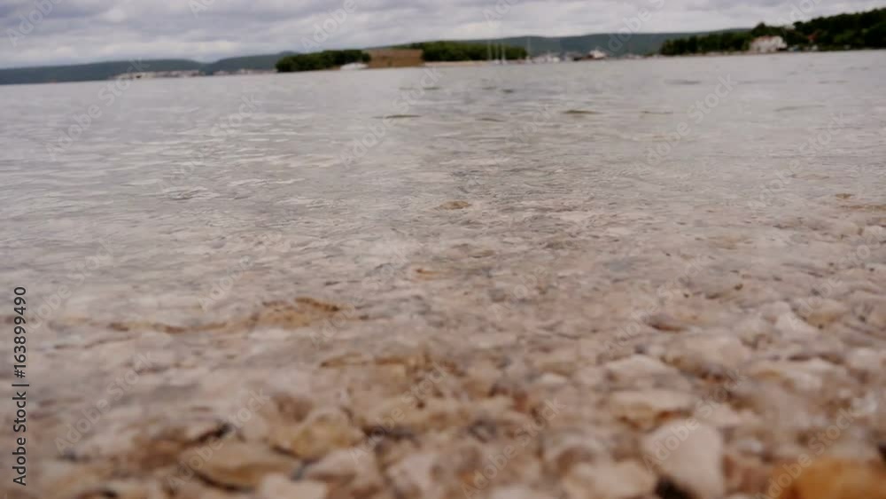 small sea waves hittig pebble shore in slow-motion HD small sea waves hittig pebble shore in slow-motion HD