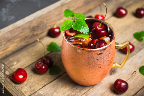 Photography Cherry moscow mule on the wooden background. Selective focus.