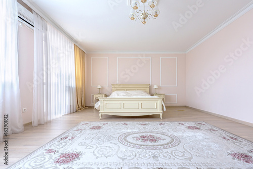 White apartment interior design bedroom with classic furniture, curtains, modern style in chisinau, cenral district, moldova photo