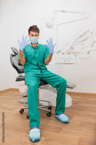 in a protective mask, the doctor is disinfected, emotional, cheerful doctor