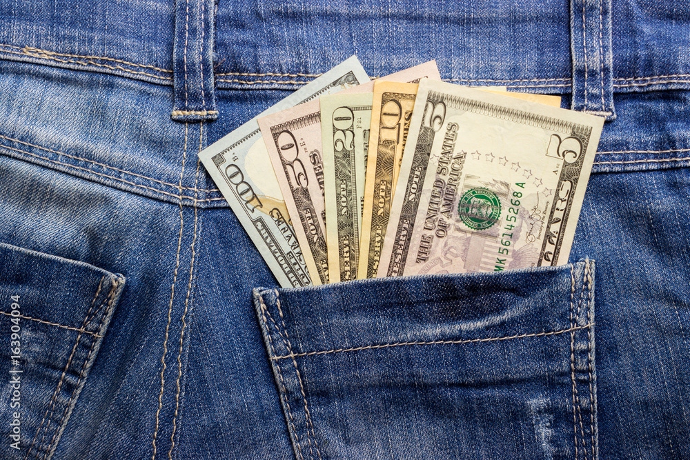 American dollar bills in jeans pocket background American dollar bills in jeans pocket background