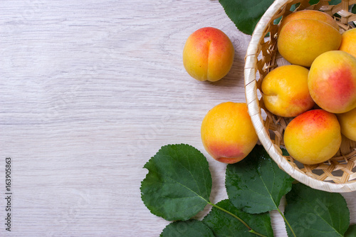 Fresh apricots in the basket On a wooden table