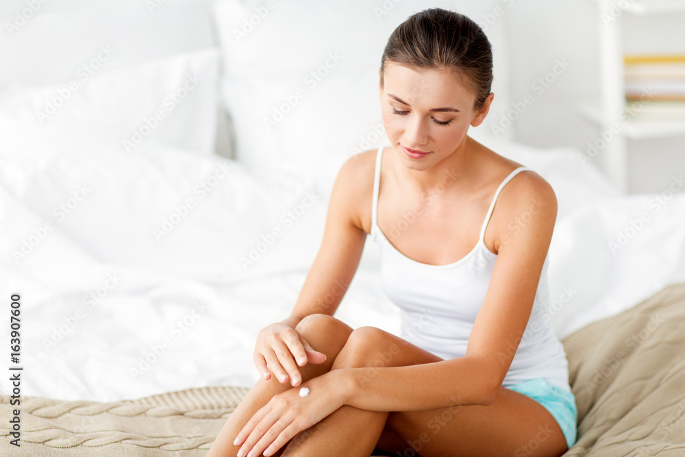 beautiful woman applying hand cream at home beautiful woman applying hand cream at home