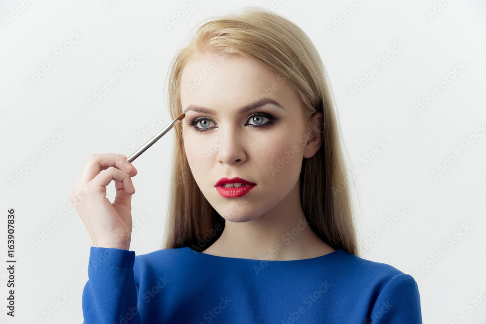 Fototapeta premium Woman with makeup brush applying eyeshadow