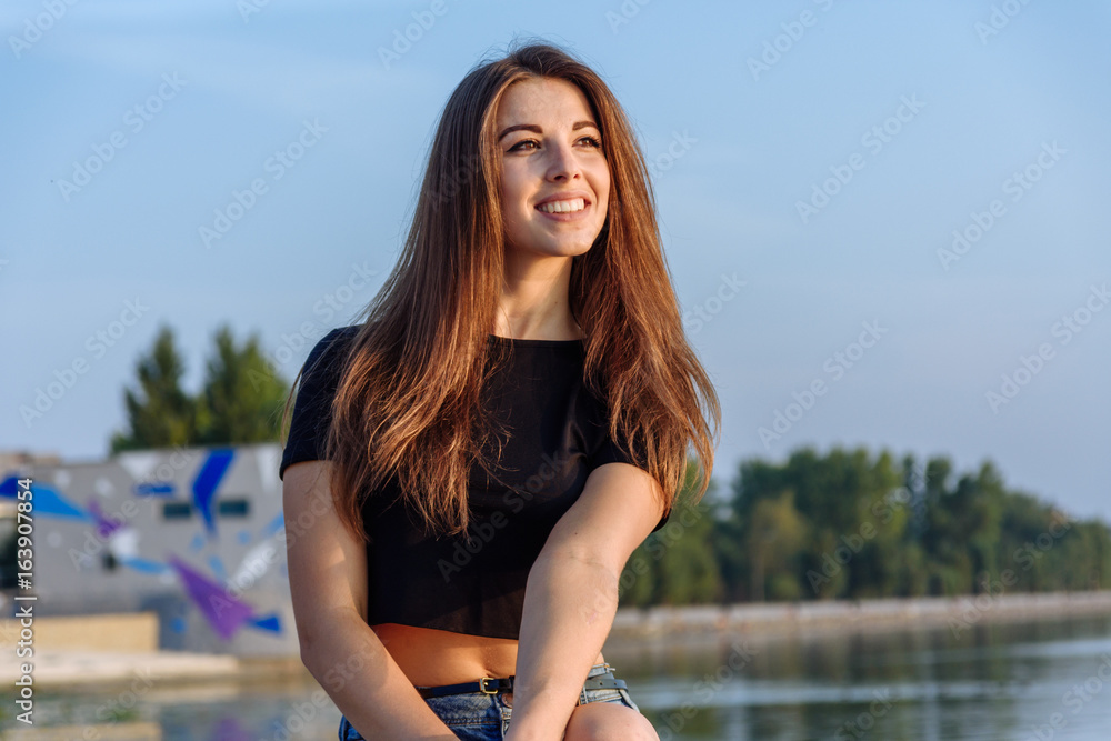 Summer spring portrait of young beautiful woman smile in the park sunset