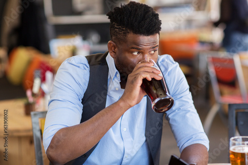 Photography man drinking draught beer at bar or pub