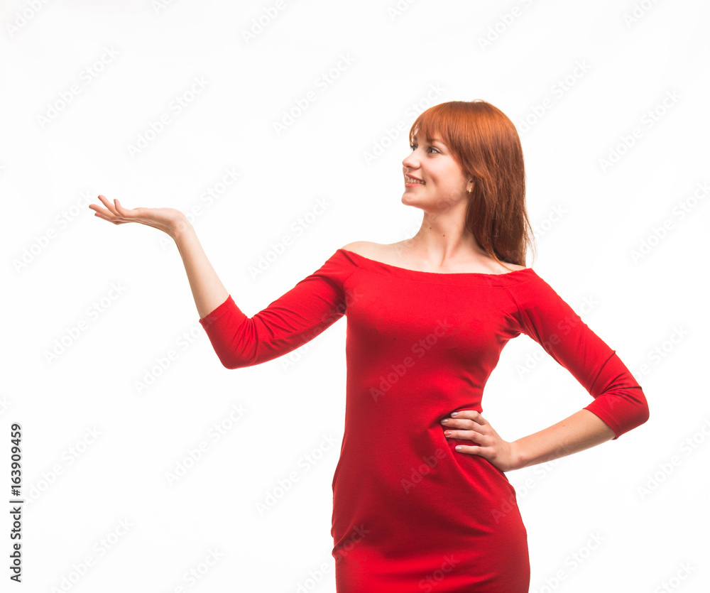 Young happy woman showing by hands on a gray background. Ideal for banners, registration forms, presentation, landings, presenting concept. Young happy woman showing by hands on a gray background. Ideal for banners, registration forms, presentation, landings, presenting concept.