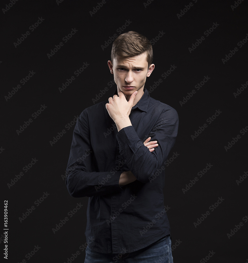 Young sexy man portrait of a confident businessman showing presentation on a black background. Ideal for banners, registration forms, presentation, landings, presenting concept. Young sexy man portrait of a confident businessman showing presentation on a black background. Ideal for banners, registration forms, presentation, landings, presenting concept.