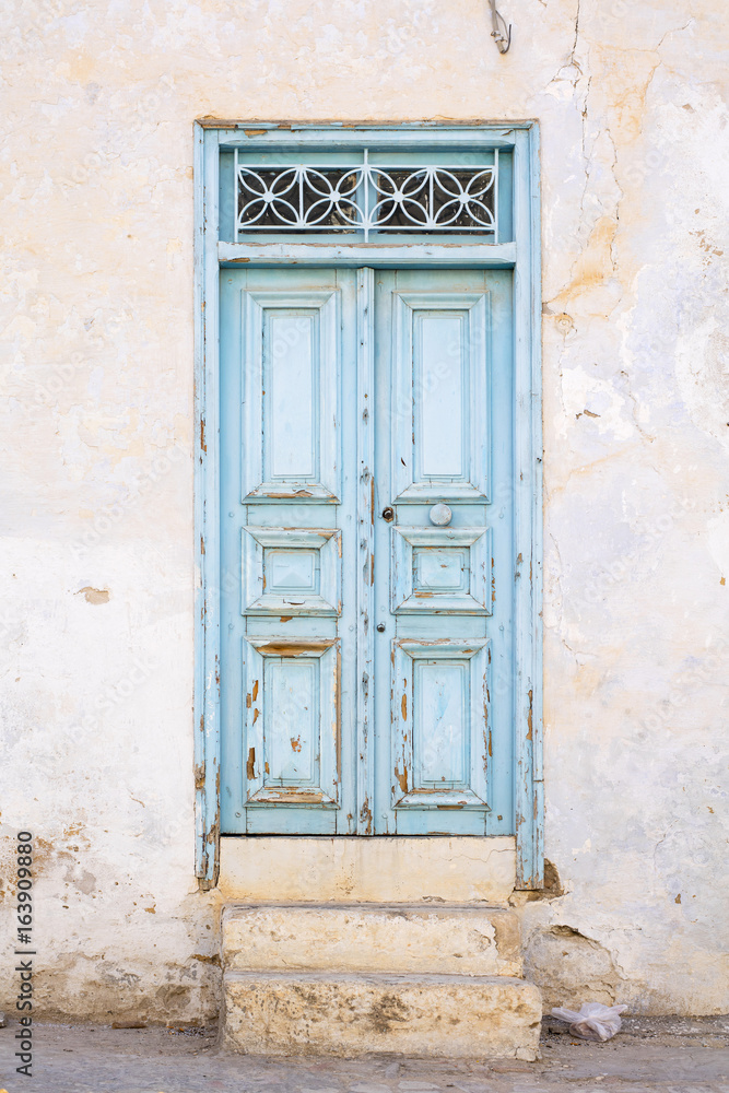 old light blue door with steps in Tunisia