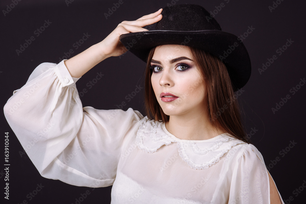 Portrait of a beautiful woman in cowboy's hat