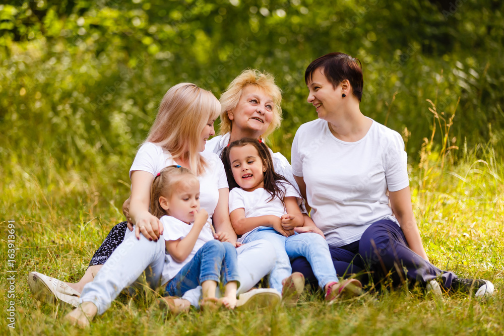 Happy grandmother with two adult daughters and two little granddaughters Happy grandmother with two adult daughters and two little granddaughters