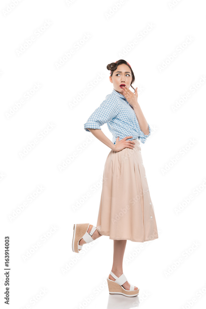Beautiful shocked asian girl in skirt and blouse looking away isolated on white Beautiful shocked asian girl in skirt and blouse looking away isolated on white