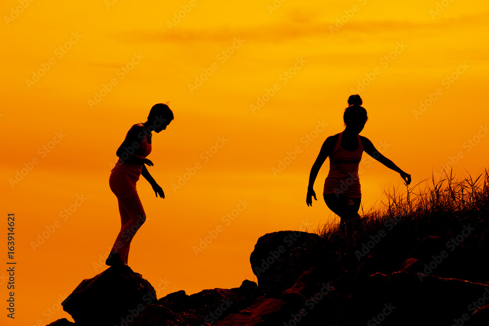 Two women friends are walking on mountain