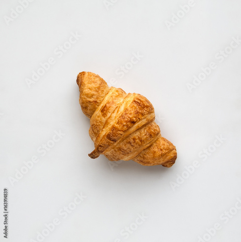 Φωτογραφία french croissants on a light background top view