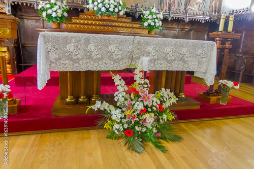altar of the Catholic Church with a bouquet of flowers in the Center