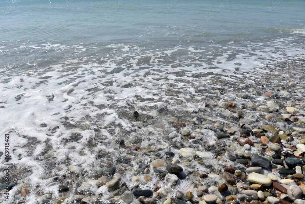 Sea waves approaching pebble stones Sea waves approaching pebble stones